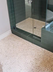 Pebble tile on bathroom floor and stall shower