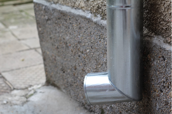 metal pipe on side of building